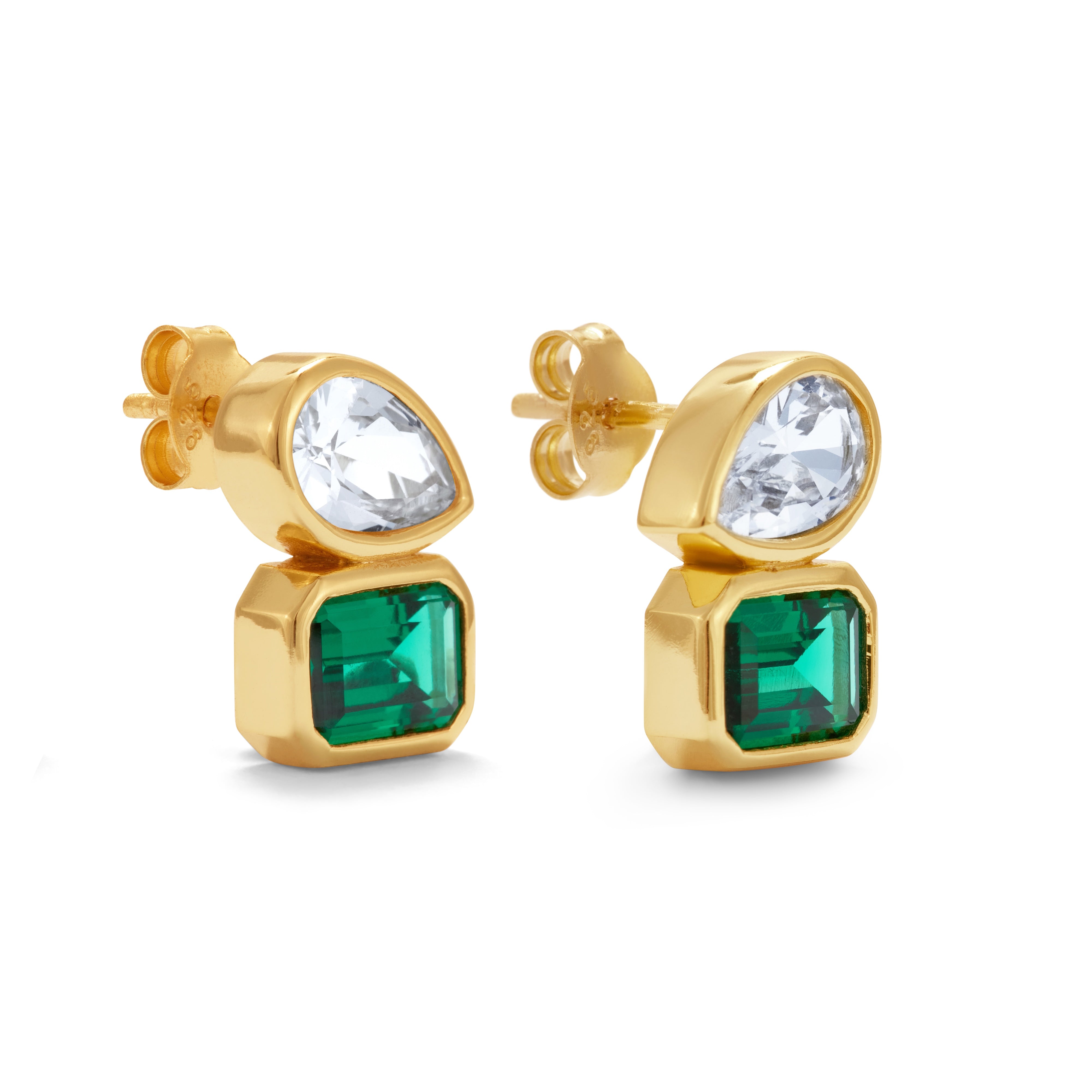 Gold earrings with green and clear gemstones on a white background