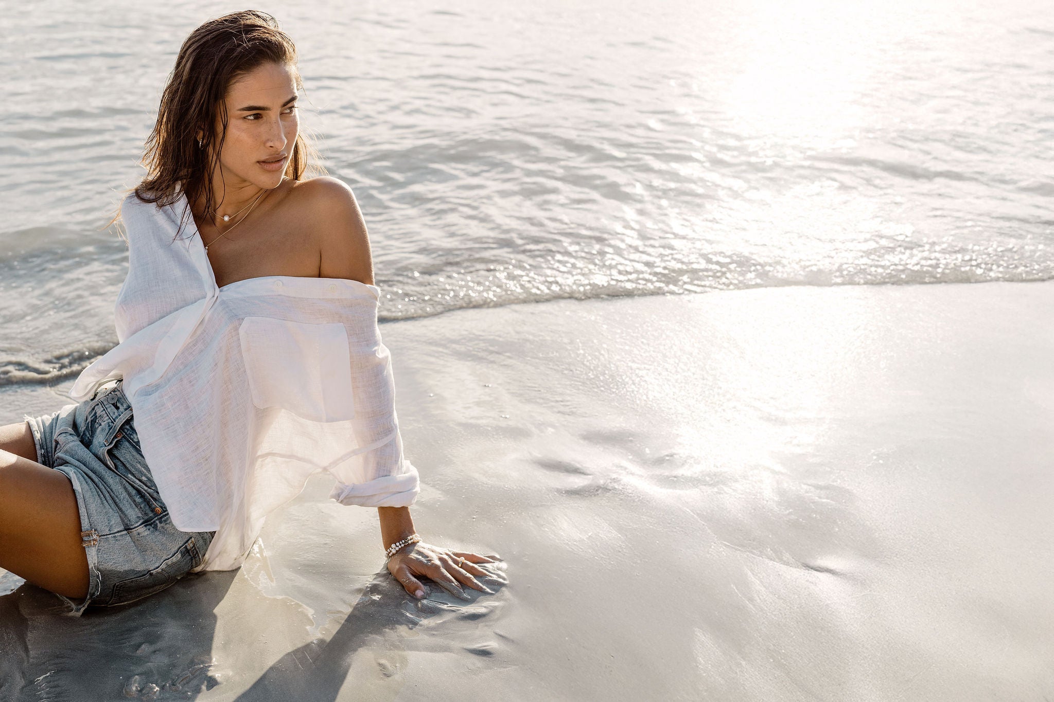 AYA jewellery on the beach at golden hour